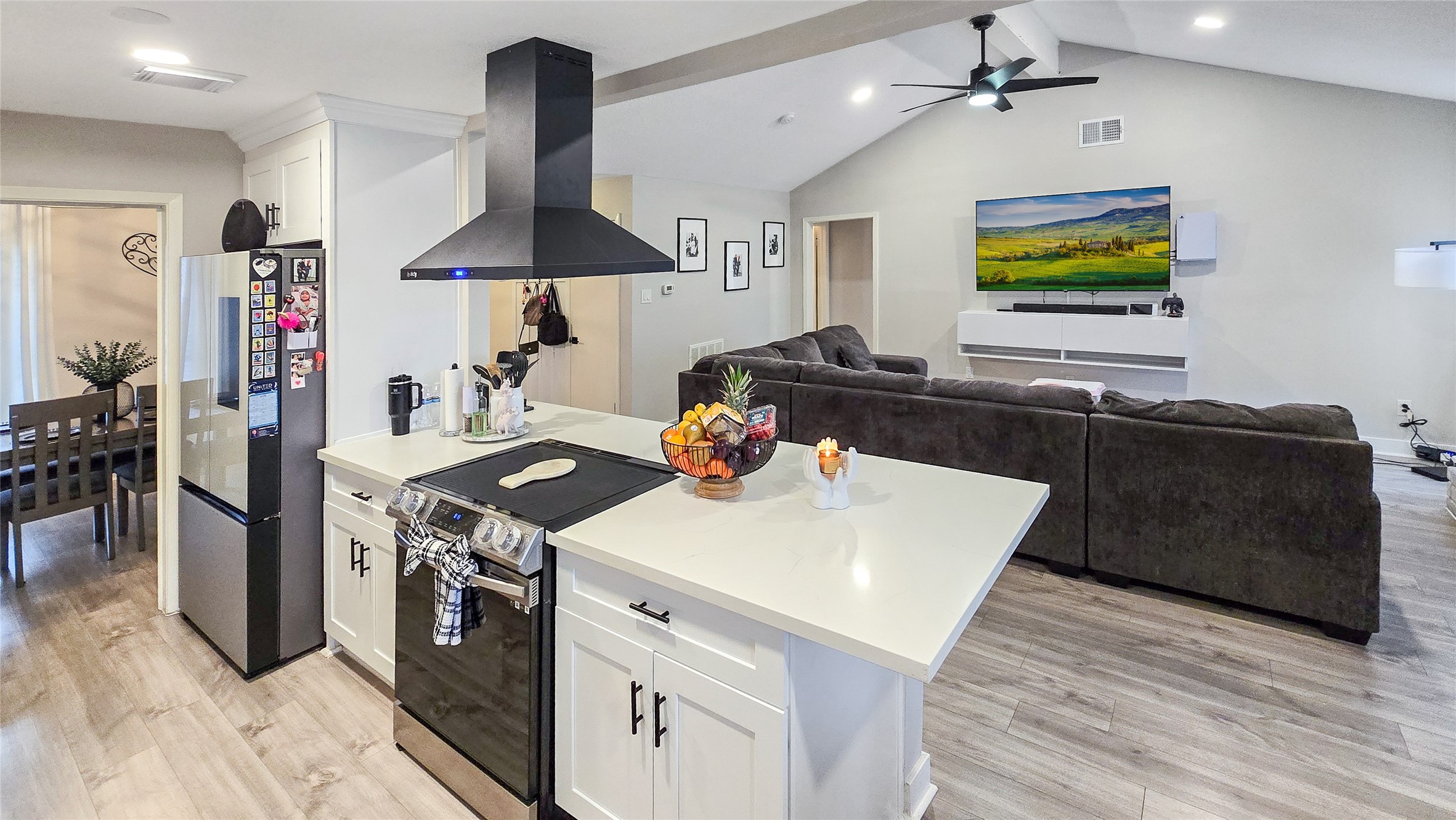 22531 John Rolfe Lane Katy, TX 77449 - Photo 10 of 19 a kitchen with stainless steel appliances a stove a chimney a sink and a dining table