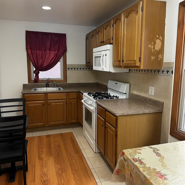 420 Stratford Road Brooklyn, NY 11218 - Photo 13 of 20 a kitchen with stainless steel appliances granite countertop a stove a sink and a microwave