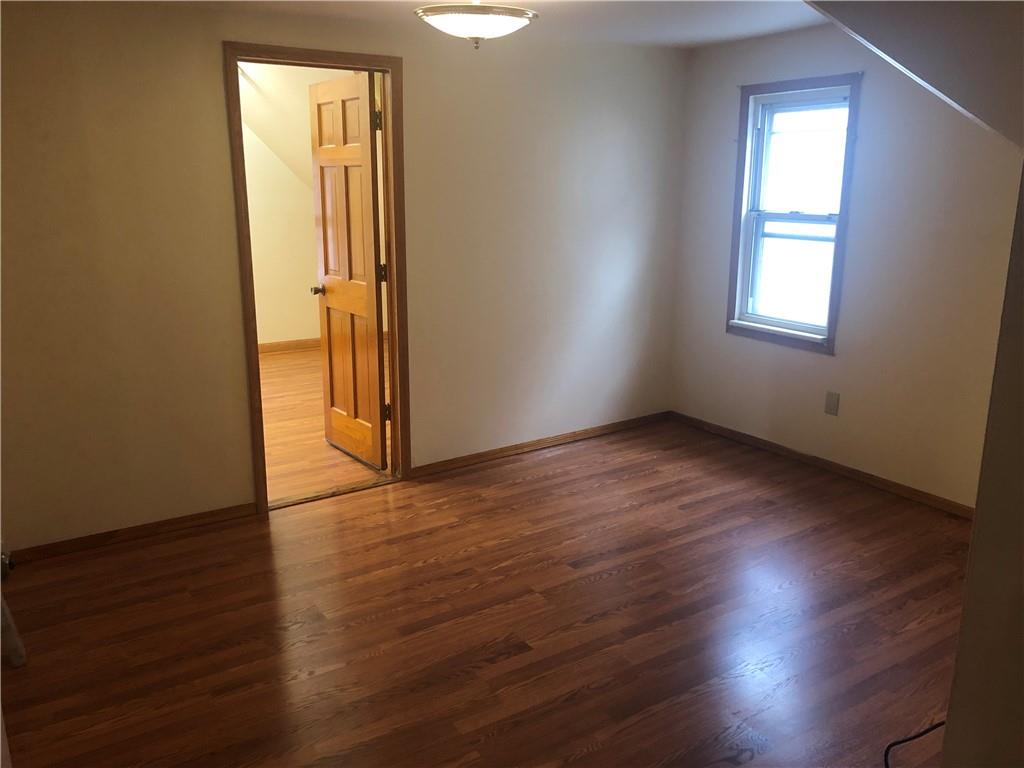 420 Stratford Road Brooklyn, NY 11218 - Photo 19 of 20 an empty room with wooden floor and windows