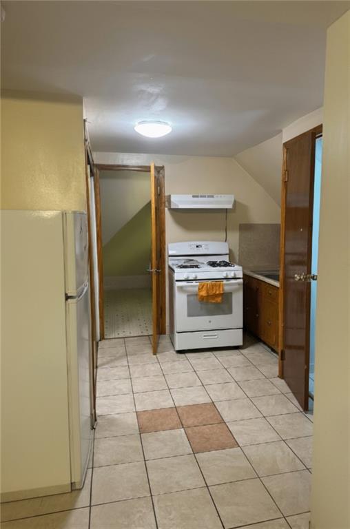 420 Stratford Road Brooklyn, NY 11218 - Photo 20 of 20 a view of a refrigerator in kitchen and an empty room in wooden floor