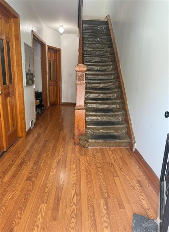 420 Stratford Road Brooklyn, NY 11218 - Photo 8 of 20 a view of a hallway with wooden floor and stairs