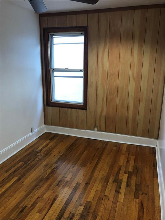 420 Stratford Road Brooklyn, NY 11218 - Photo 10 of 20 a view of an empty room with wooden floor and a window