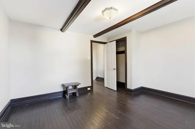 a view of a room with wooden floor and lounge chair