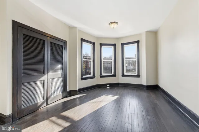 a view of a room with wooden floor and window