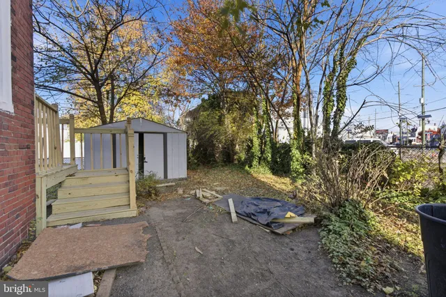 a view of a house with a yard and tree s