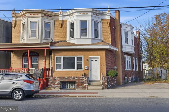 front view of a house with a cars parked in front of it