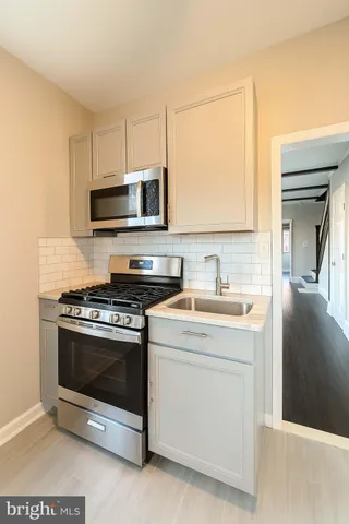 a kitchen with a stove and a microwave