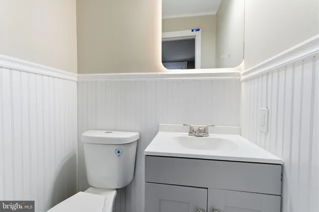 a bathroom with a sink a toilet and a mirror