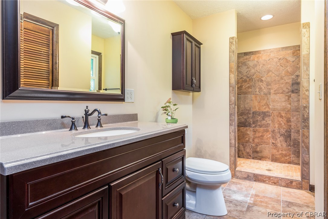 10060 Figg Shop Road Gloucester, VA 23061 - Photo 20 of 38 Ensuite owner's bathroom with ceramic tile and walk in tile shower.
