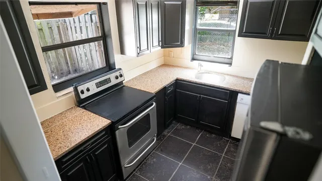 a kitchen with wooden cabinets and a stove
