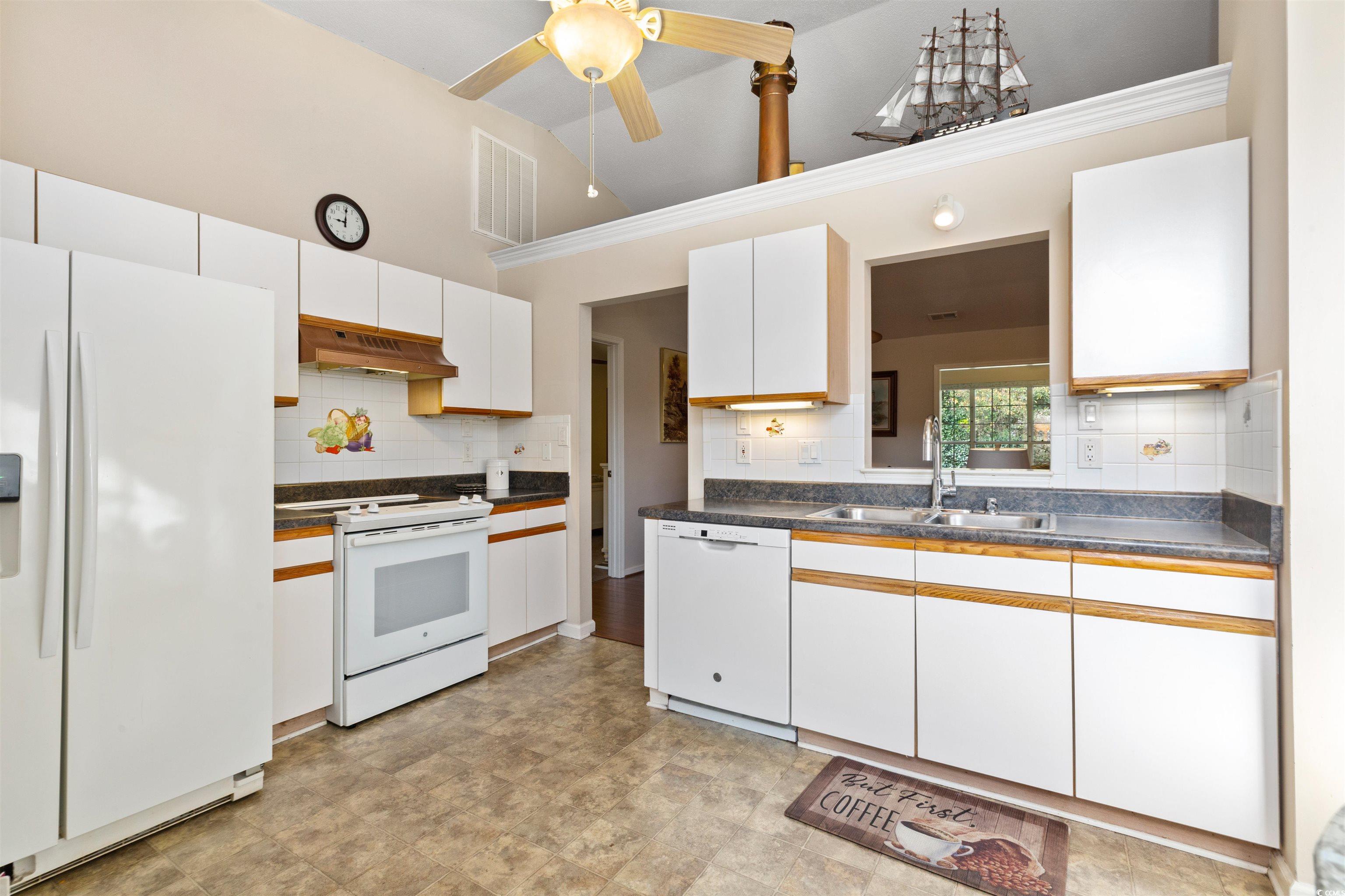 675 Bluebird Lane Murrells Inlet, SC 29576 - Photo 5 of 40 Kitchen featuring white appliances, dark counterto