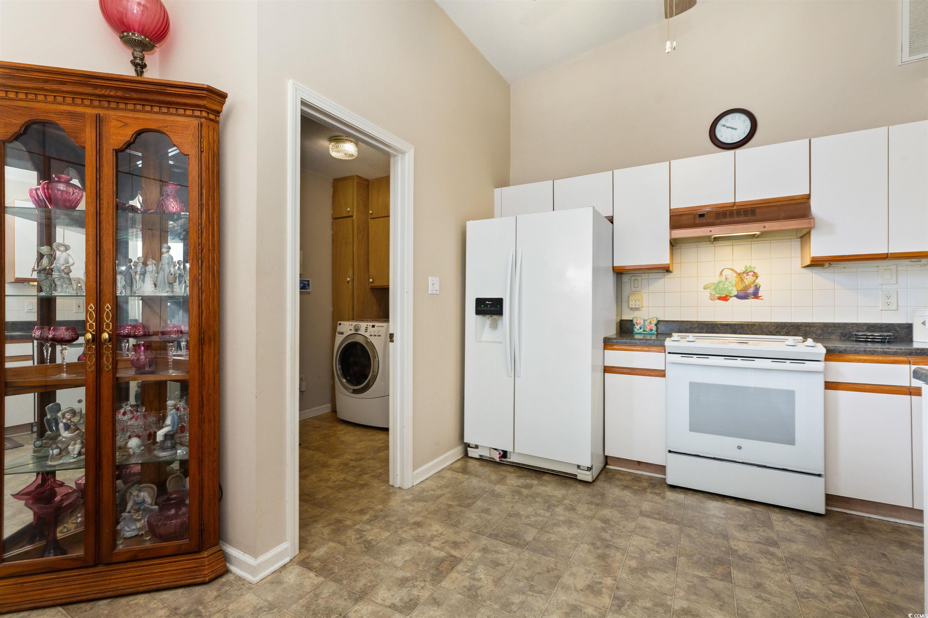 675 Bluebird Lane Murrells Inlet, SC 29576 - Photo 6 of 40 Kitchen with white appliances, washer / clothes dr