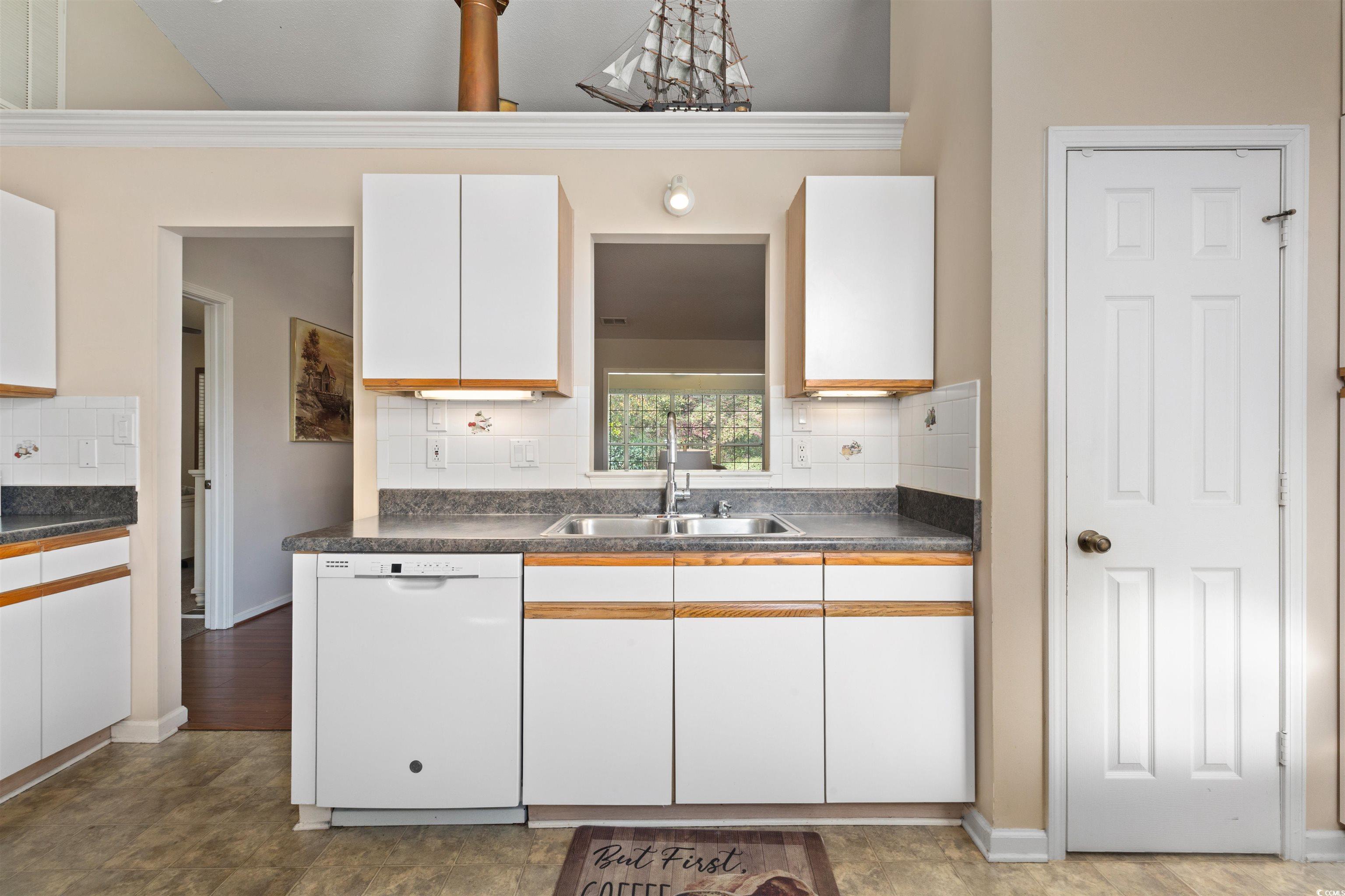 675 Bluebird Lane Murrells Inlet, SC 29576 - Photo 7 of 40 Kitchen featuring a sink, dark countertops, dishwa