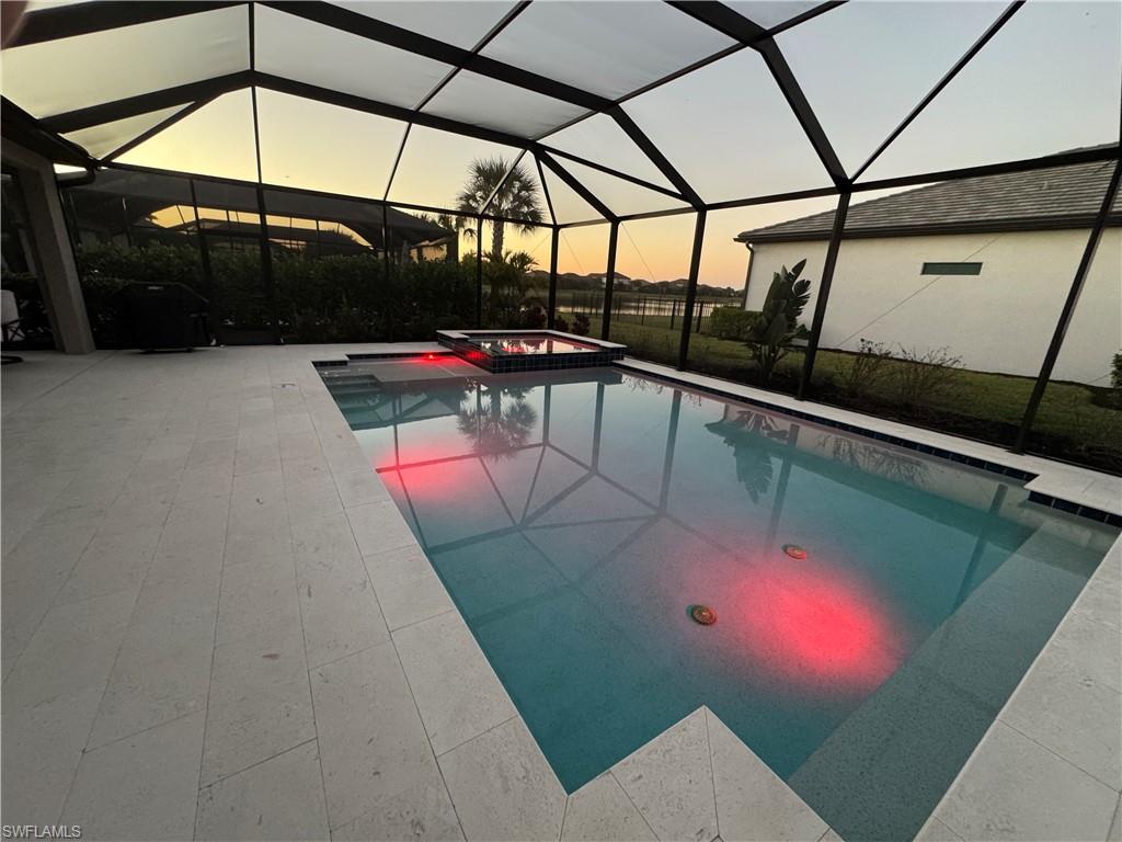 18298 Ridgeline Drive Estero, FL 33928 - Photo 30 of 49 Integrated pool / hot tub with a lanai, a sunroom, and a patio