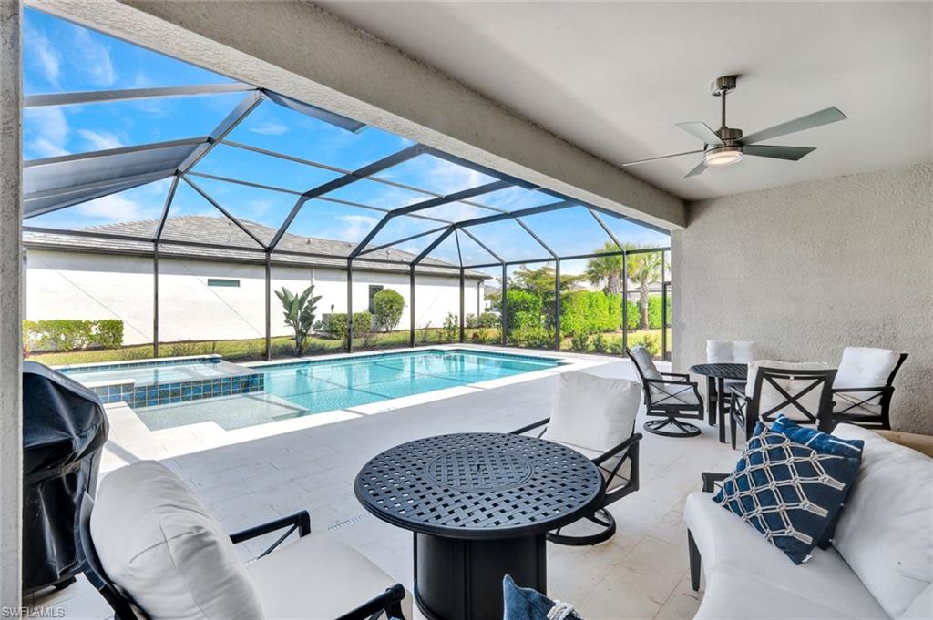 18298 Ridgeline Drive Estero, FL 33928 - Photo 3 of 49 Integrated pool / hot tub with a patio area, a sunroom, a lanai, and area for grilling