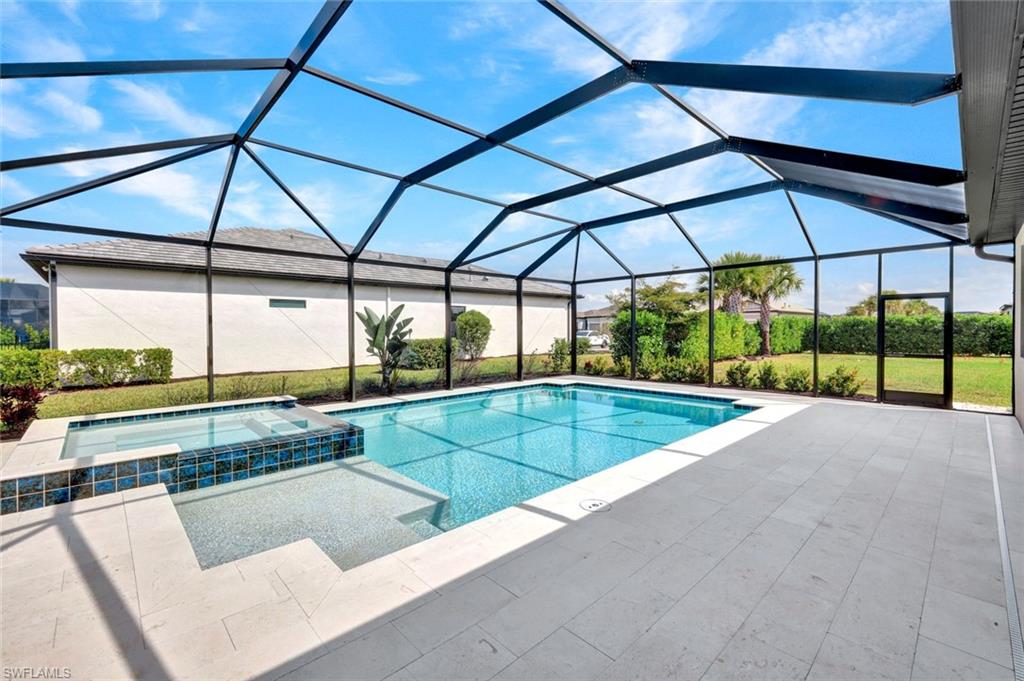 18298 Ridgeline Drive Estero, FL 33928 - Photo 31 of 49 Integrated pool / hot tub with a sunroom, a lanai, and a patio