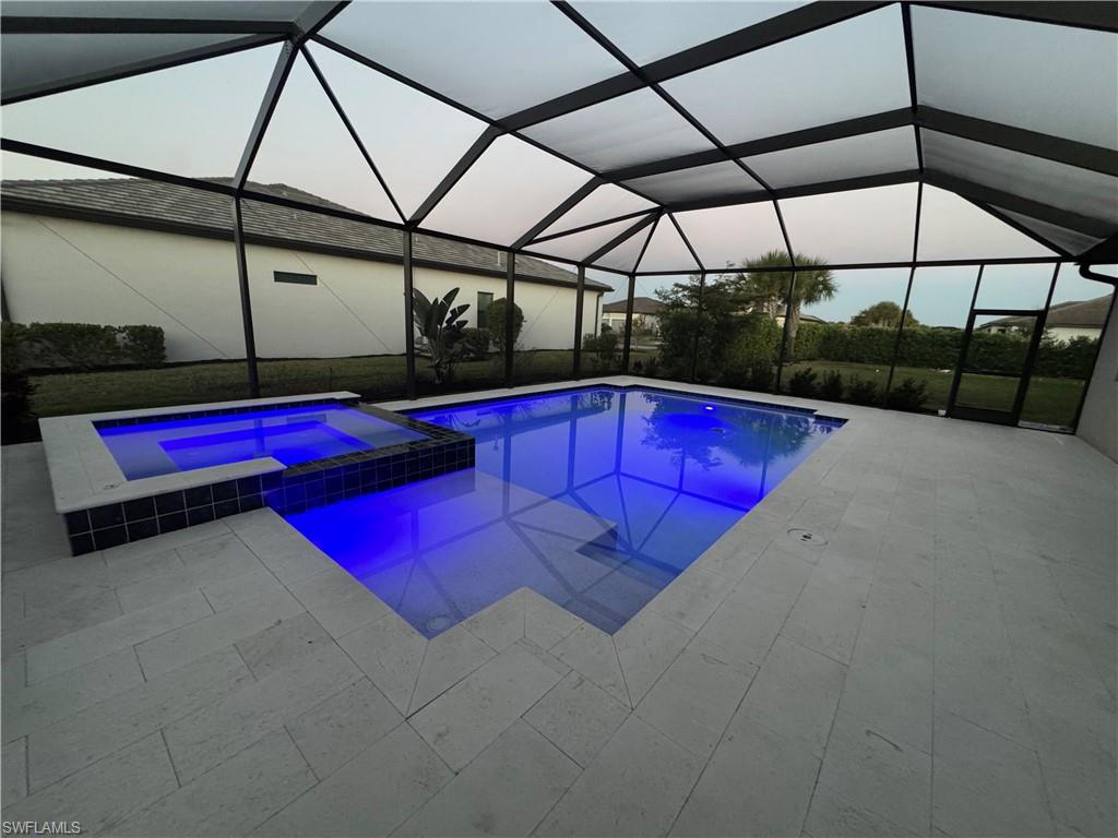 18298 Ridgeline Drive Estero, FL 33928 - Photo 34 of 49 Combined pool / hot tub with a sunroom, a lanai, and a patio area