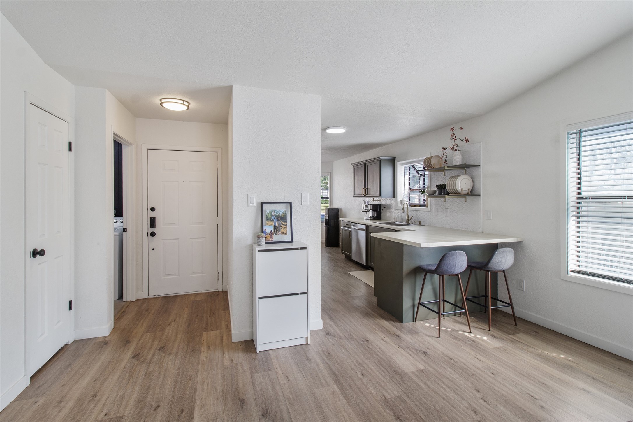 3908 Sierra Court Bryan, TX 77802 - Photo 12 of 27 a kitchen with white cabinets and stainless steel appliances