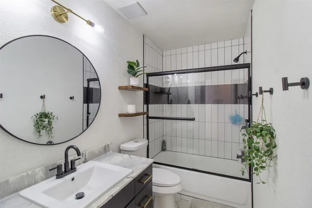 a bathroom with a sink toilet and shower
