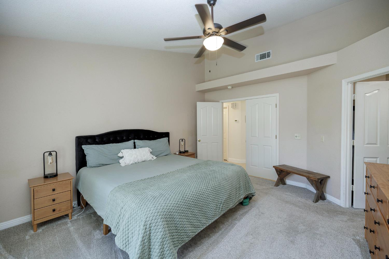 230 Meyenberg Avenue Ripon, CA 95366 - Photo 33 of 52 a bedroom with a bed and a chandelier