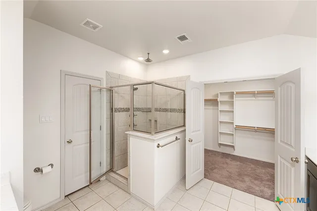 a bathroom with a shower sink and cabinets