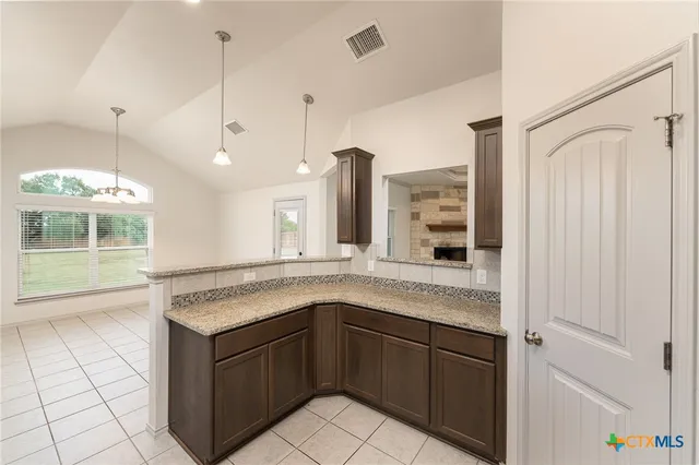 a kitchen with a sink and chandelier