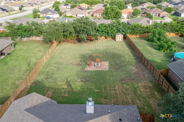 an aerial view of residential houses with outdoor space