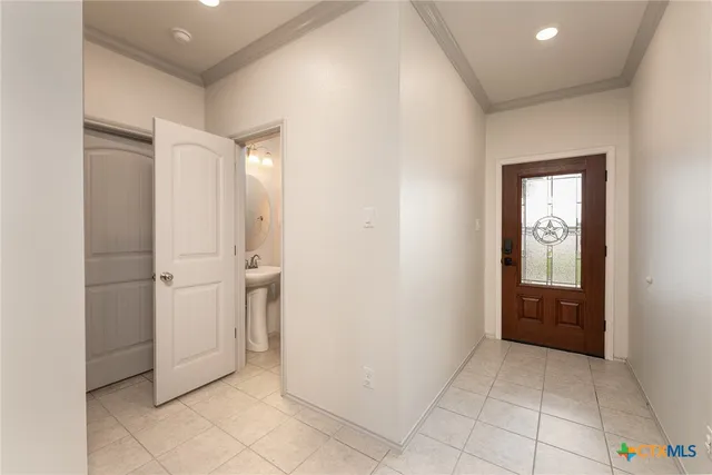 a view of a hallway to rooms and bathroom
