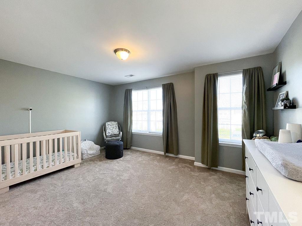 7853 Silverthread Lane Raleigh, NC 27617 - Photo 13 of 15 a bedroom with furniture and a window
