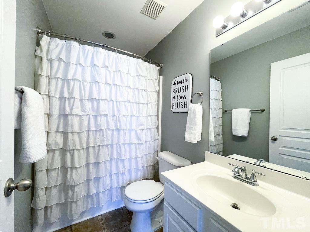 7853 Silverthread Lane Raleigh, NC 27617 - Photo 14 of 15 a bathroom with a sink toilet and shower