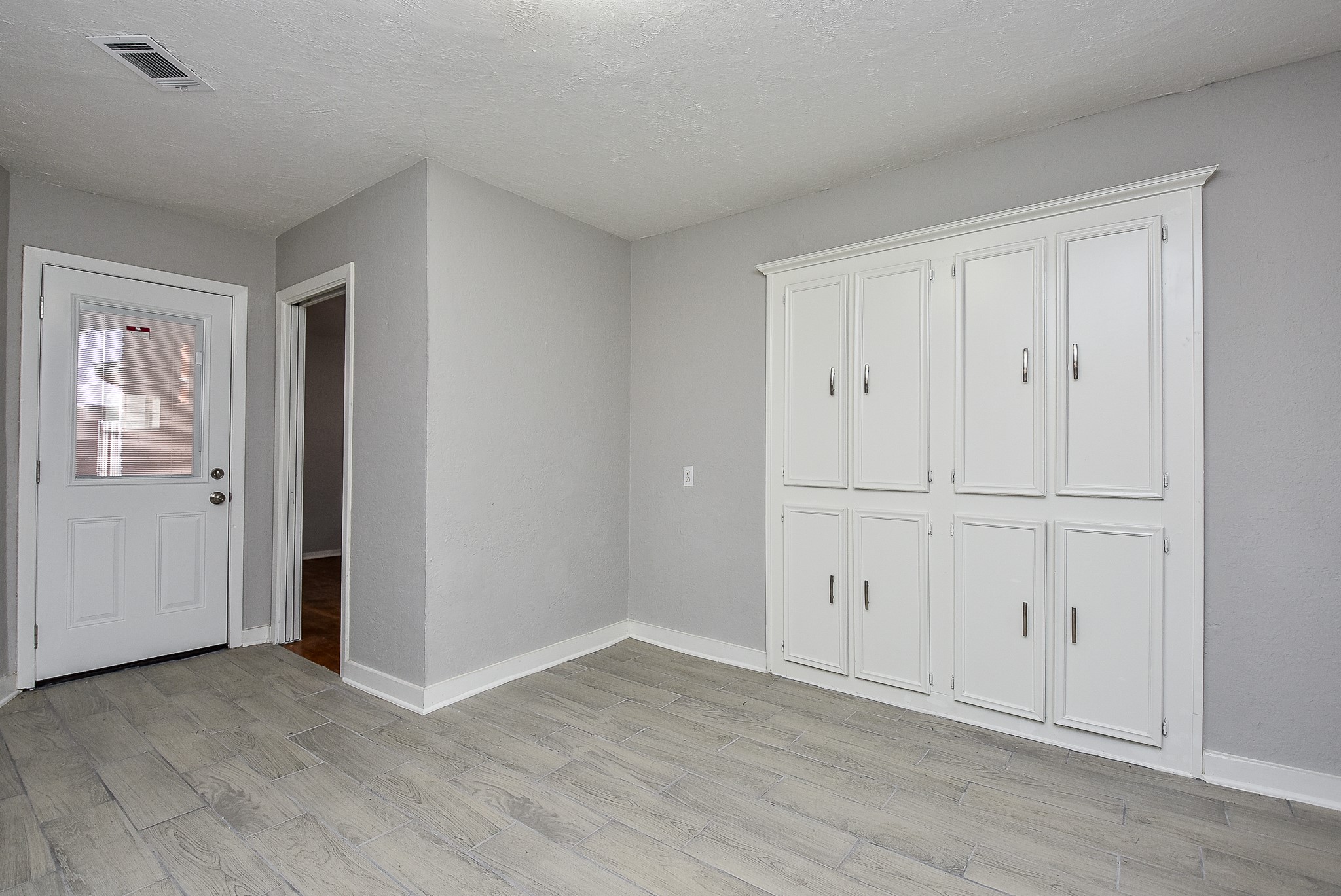 2509 Oakcliff Street Houston, TX 77023 - Photo 16 of 31 a view of an empty room with wooden floor