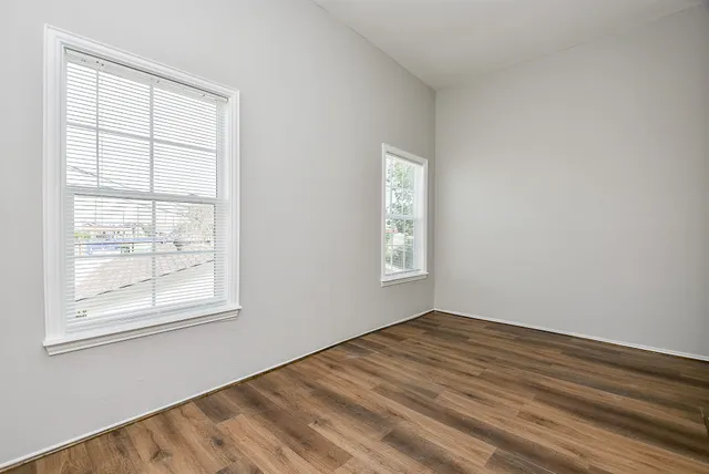 wooden floor in an empty room with a window