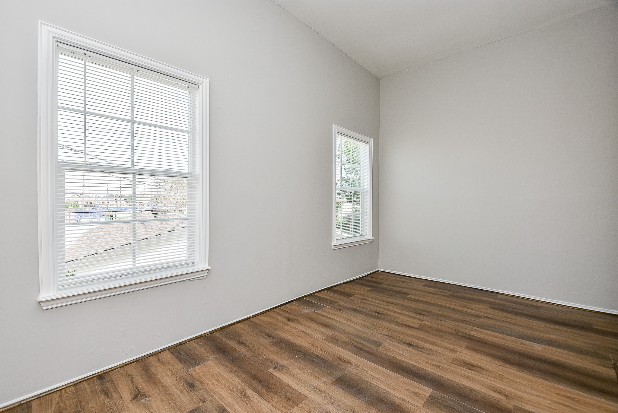 2509 Oakcliff Street Houston, TX 77023 - Photo 22 of 31 wooden floor in an empty room with a window