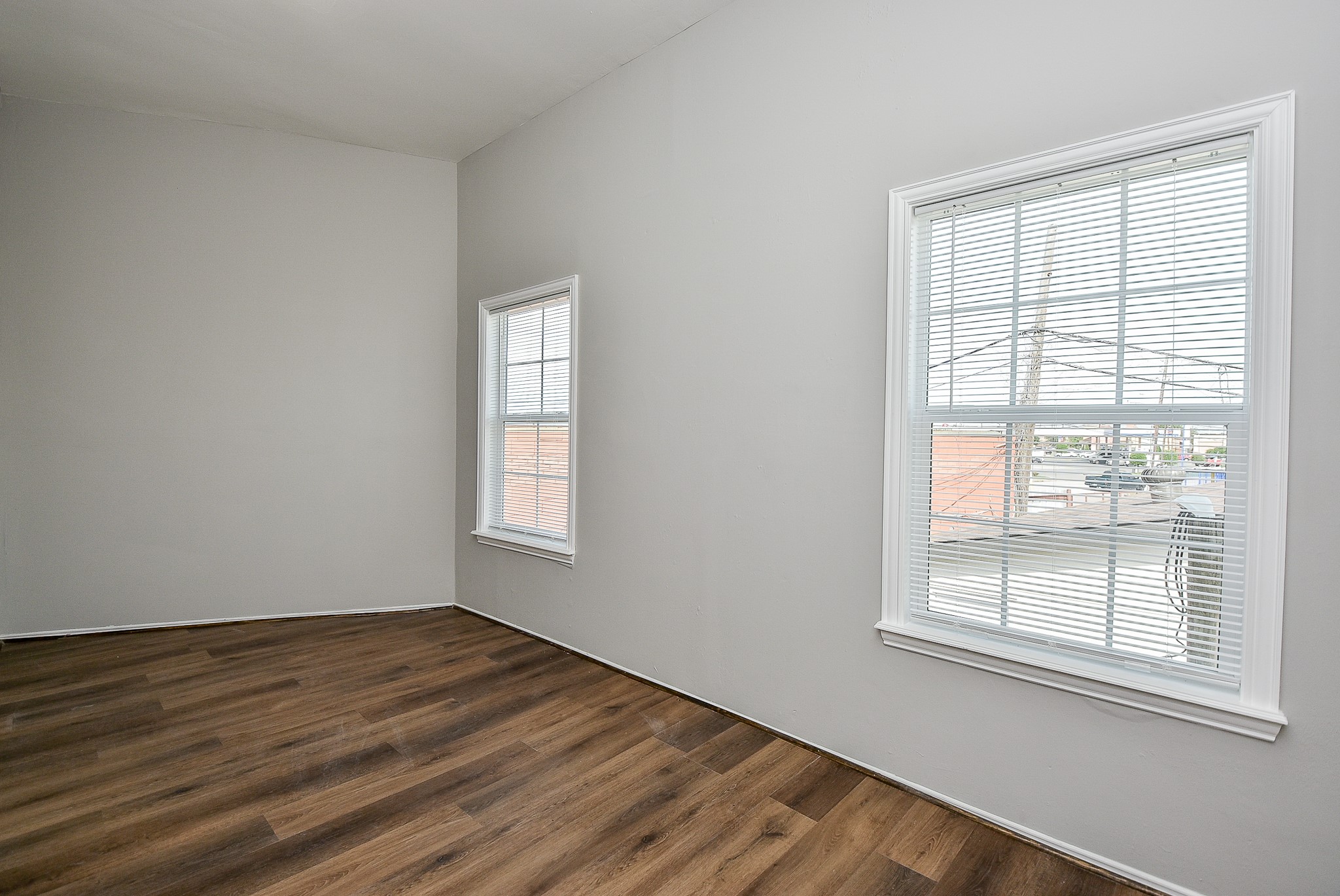 2509 Oakcliff Street Houston, TX 77023 - Photo 23 of 31 a view of an empty room with wooden floor and a window