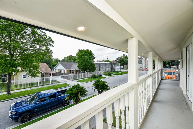 a view of a porch with furniture and garden