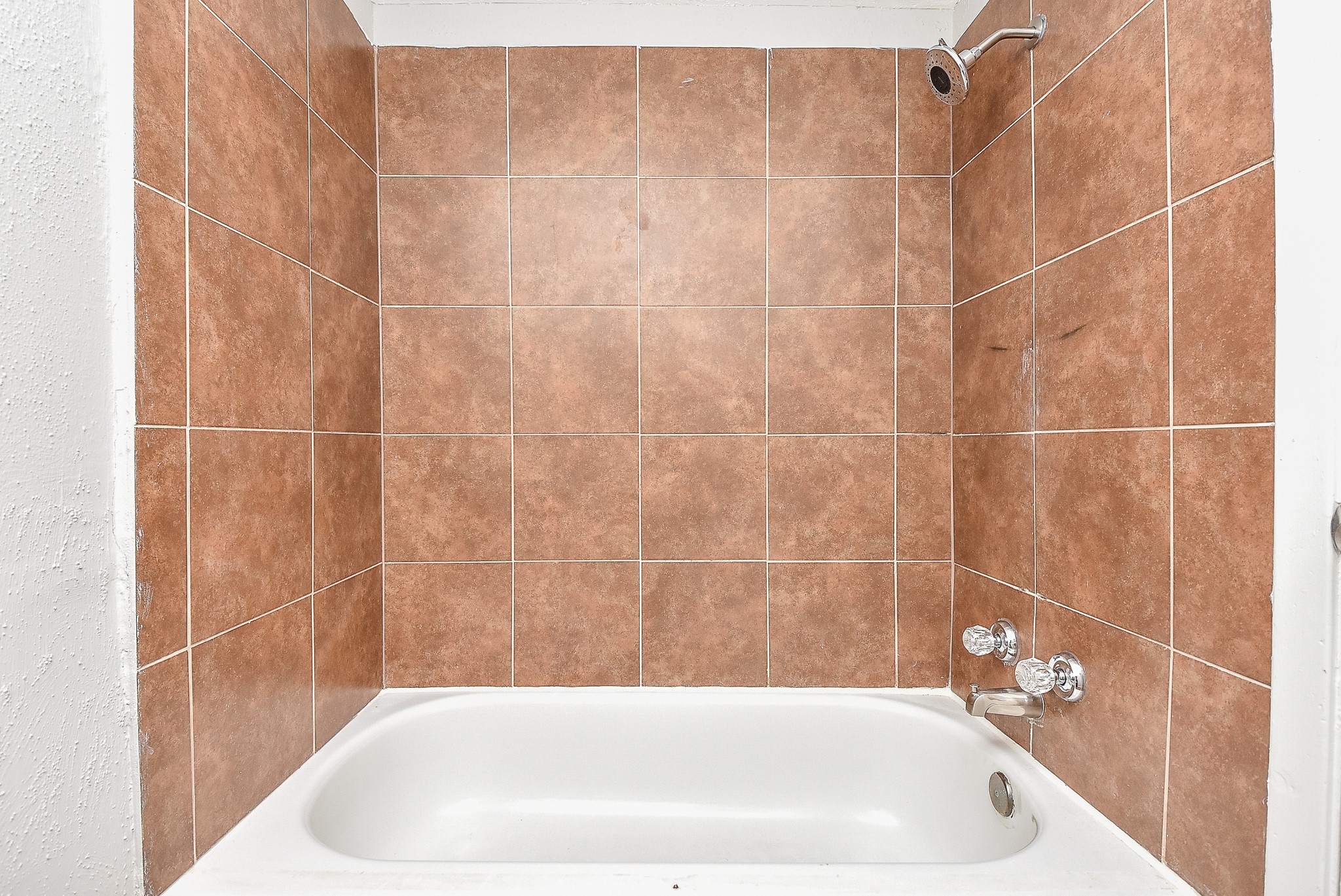 2509 Oakcliff Street Houston, TX 77023 - Photo 30 of 31 a bathroom with a white bath tub and a shower