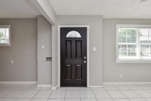 a view of a hallway with front door