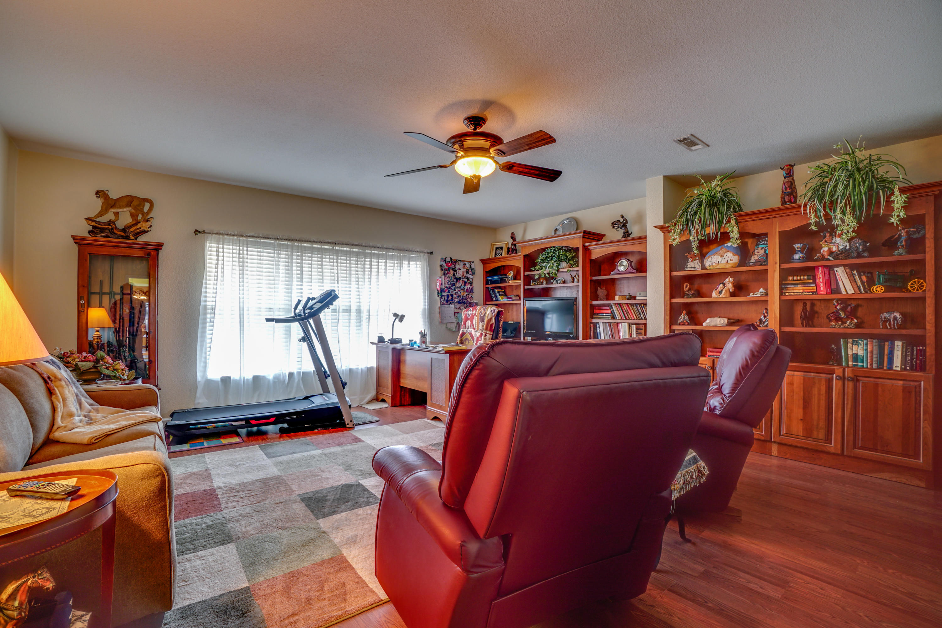 1940 Eldridge Road Cottondale, FL 32431 - Photo 22 of 42 a living room with furniture a piano and a bookshelf