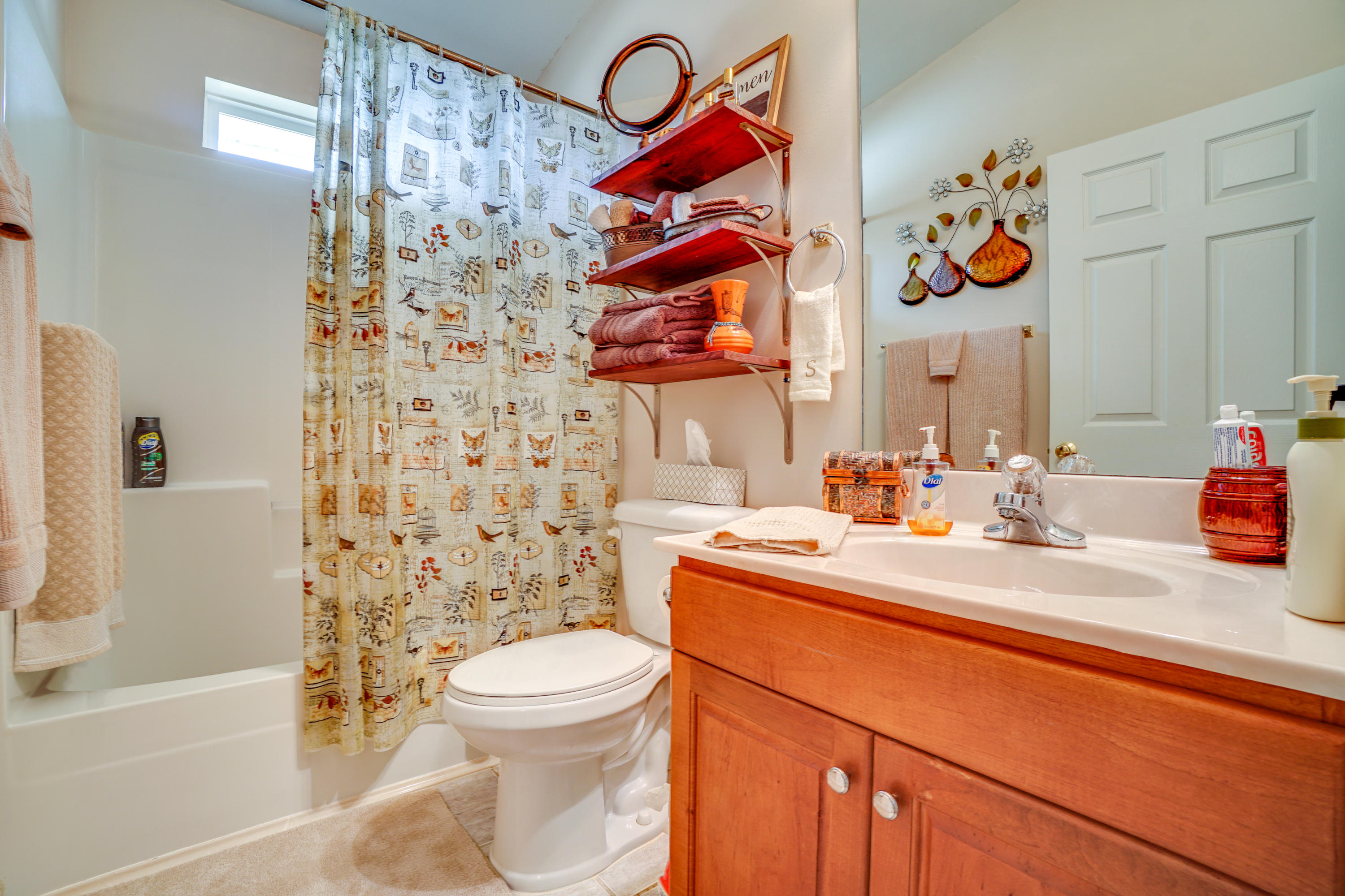 1940 Eldridge Road Cottondale, FL 32431 - Photo 31 of 42 a bathroom with a sink a toilet and shower curtain
