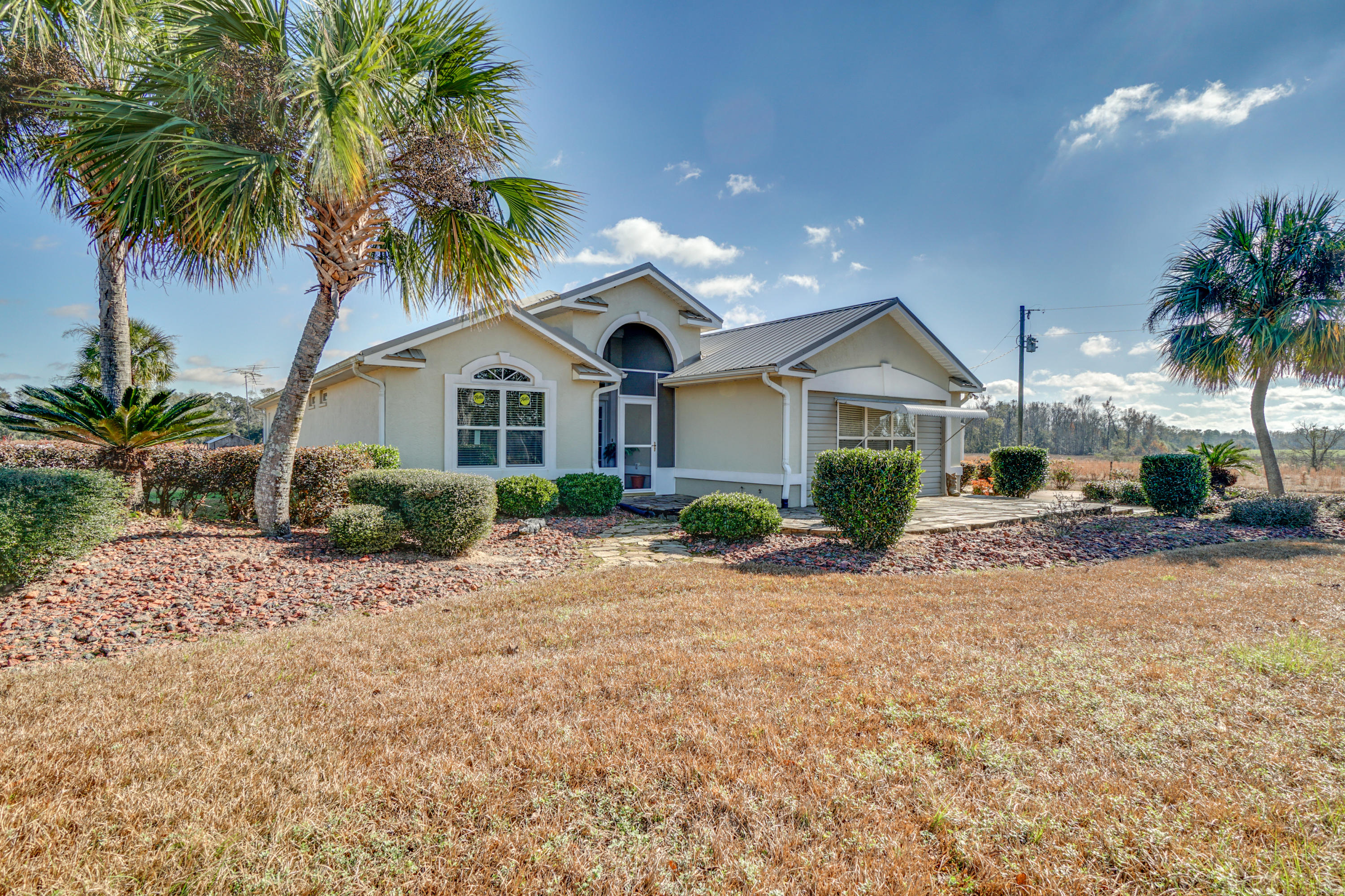 1940 Eldridge Road Cottondale, FL 32431 - Photo 8 of 42 a front view of a house with a yard and garage