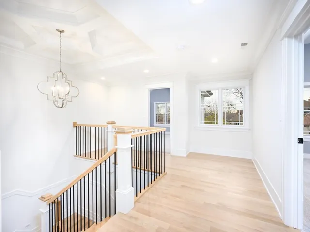 a view of a room with wooden floor and windows