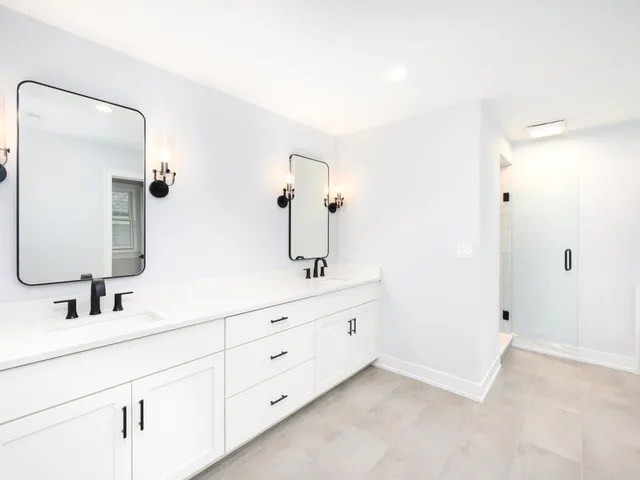 a bathroom with a double vanity sink and mirror