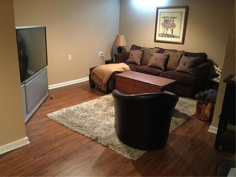 1323 Ashton Road Sharon, PA 16146 - Photo 22 of 25 FAMILY ROOM IN THE WATERPROOFED BASEMENT...EASY TO CARE FOR FLOORING, GLASS BLOCK WINDOWS.THE TV CAN STAY...IT'S GREAT FOR VIDEO GAMES & MOVIES.