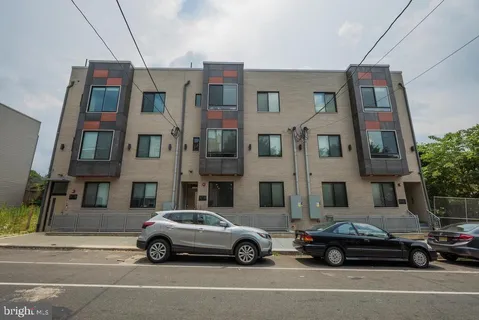 a car parked in front of a big house