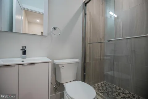 a bathroom with a toilet a sink and shower
