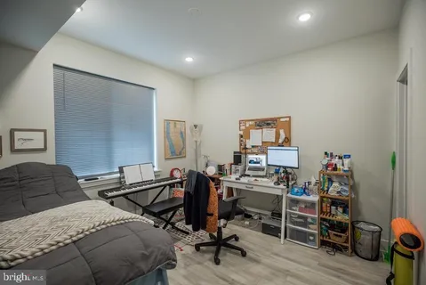 a view of a workspace with furniture and wooden floor
