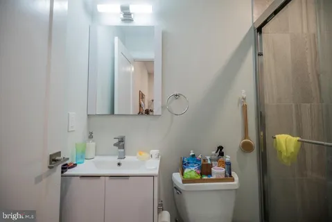 a bathroom with a sink mirror vanity and toilet