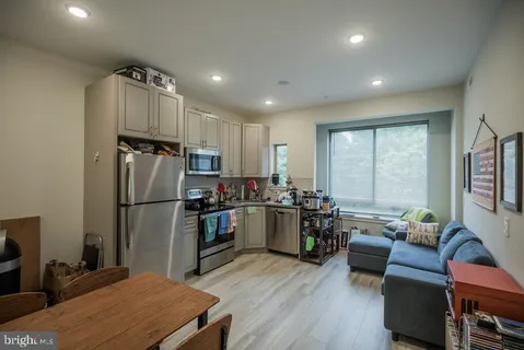 a kitchen with sink refrigerator and window