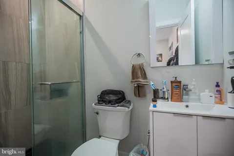 a bathroom with a sink a toilet and a mirror