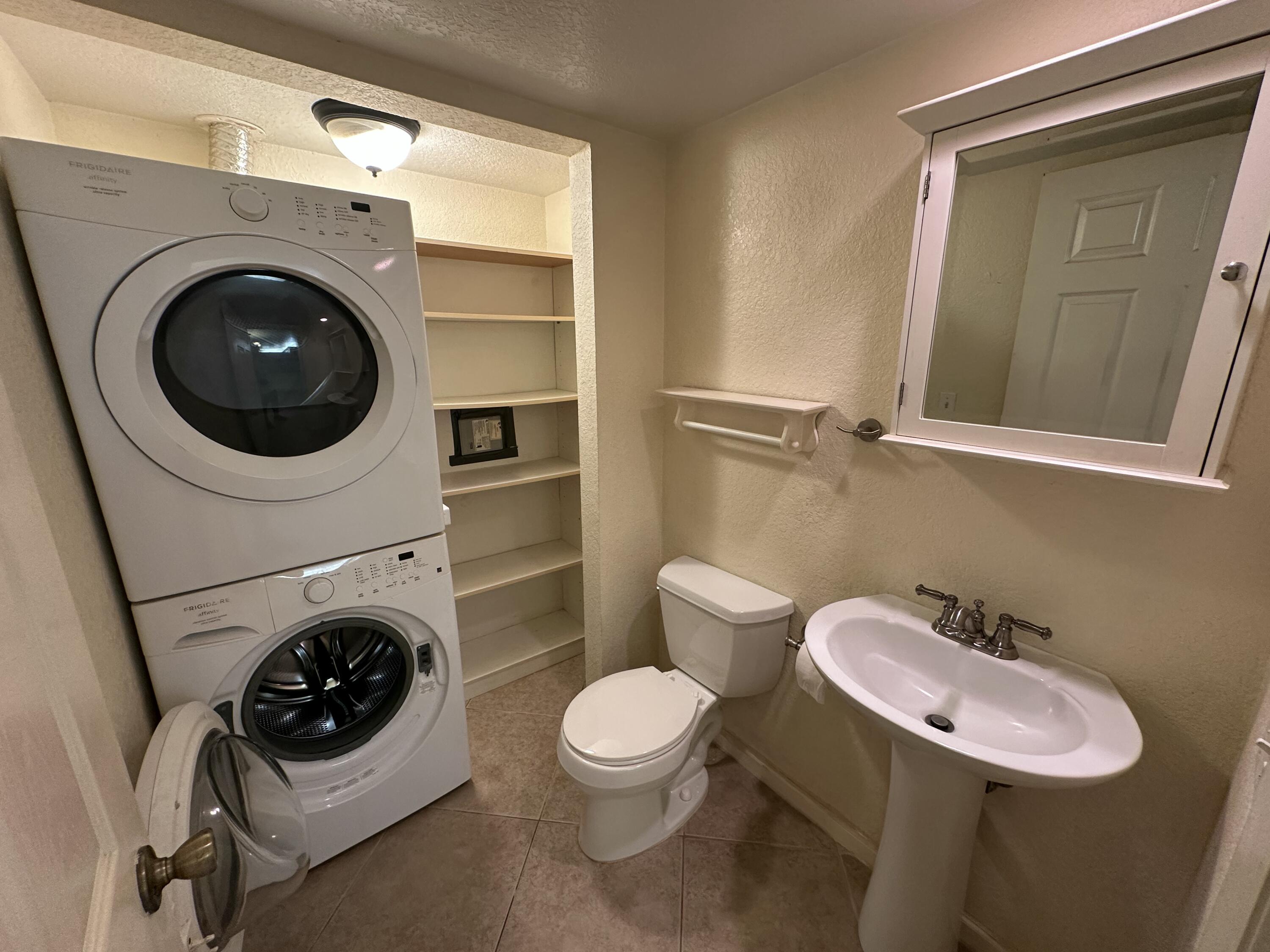 622 Springdale Circle Palm Springs, FL 33461 - Photo 11 of 13 a bathroom with a toilet a sink and mirror